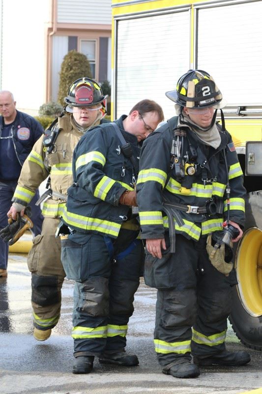 Firefighters gathered nearby a fire truck